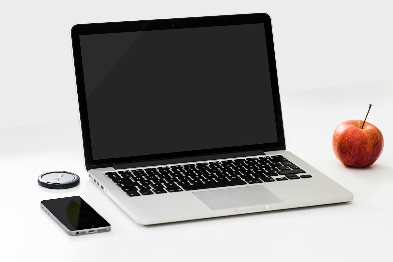 Photo by karsten madsen Macbook Pro Near Iphone and Apple Fruit